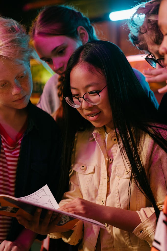 A group of diverse teenagers enjoying a fun indoor gathering under neon lights.
